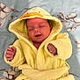 Oscar joined the competition — help win amazing prizes! baby, sleeping, yellow, bathrobe, duck, hood, blanket, floral_pattern, infant, cute, soft, cozy, child, smiling, relaxed, indoors, portrait, apparel, newborn, hands