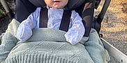 Oscar joined the competition — help win amazing prizes! baby, infant, stroller, blanket, clothing, outdoor, sunlight, happy, smile, face, person, seat, safety_harness, footwear, nature, pavement, head_support, cute, child, warm