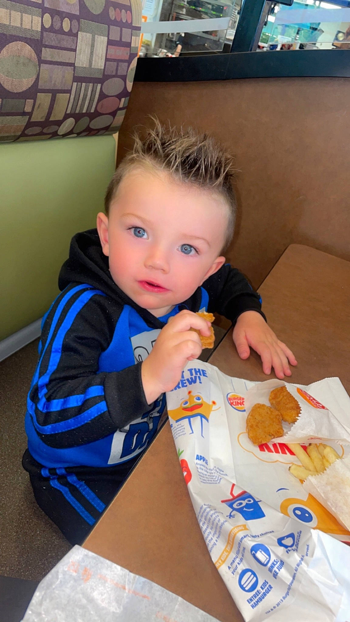 Brantley is registered to the contest to win money with this photo: baby, breakfast, chair, child, comfort_food, eating, finger, fun, junk_food, leisure, nail, person, plate, play, recreation, room, sharing, sitting, t_shirt, table