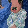 baby, sleeping, blanket, onesie, dinosaur_pattern, face_filter, dog_ears, dog_nose, infant, cozy, soft_texture, child, cute, closed_eyes, hand, blue, white, patterned_clothing, portrait, indoors