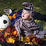 Lucian is registered to the contest to win money with this photo: child, toddler, costume, halloween, pumpkin, autumn_leaves, blanket, outdoor, grass, festive, fall, cute, face, expression, sitting, nature, holiday, decoration, seasonal, portrait