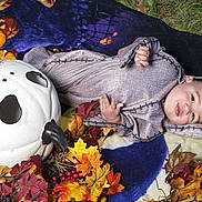 Lucian joined the competition — help win amazing prizes! baby, child, costume, halloween, pumpkin, autumn_leaves, blanket, outdoor, face, cute, festive, holiday, seasonal, smiling, person, headwear, decoration, nature, grass, portrait