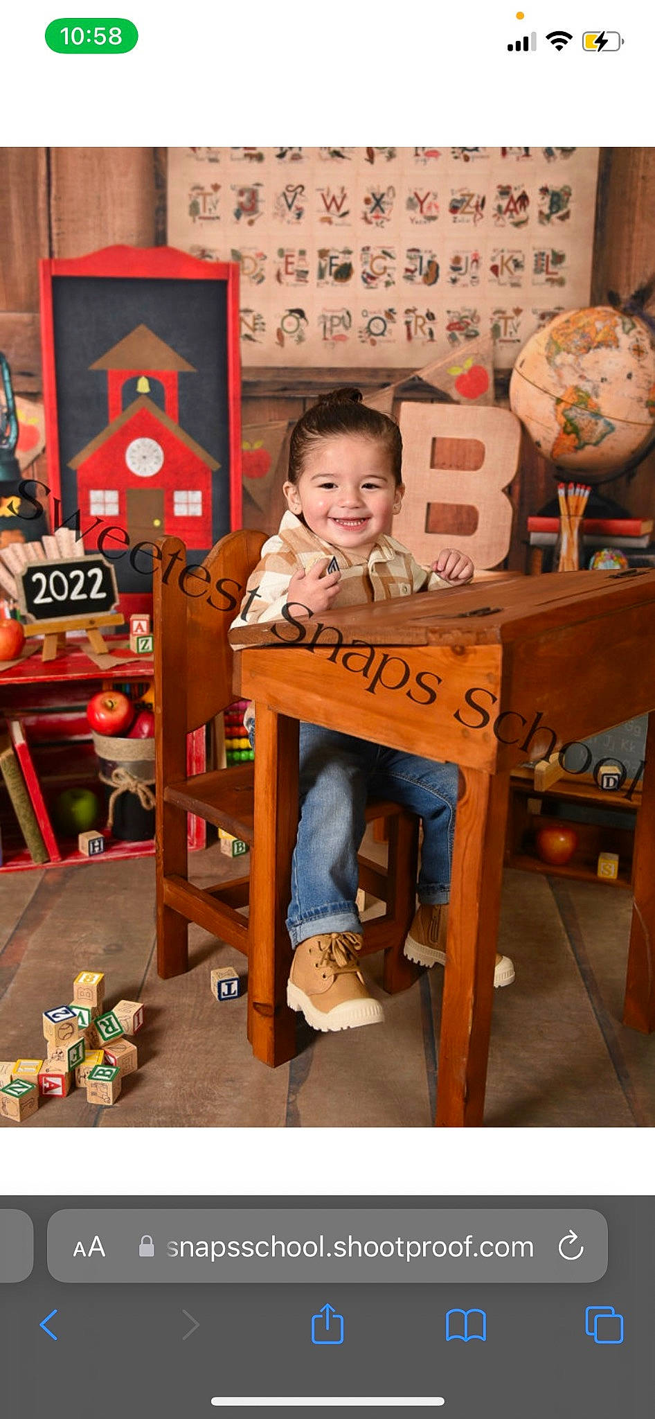 Jaivyn is registered to the contest to win money with this photo: chair, child, event, fun, joy, leisure, orange, person, play, room, sitting, smile, stool, stuffed_toy, t_shirt, toddler, toy, visual_arts, wood