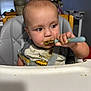 Silas is registered to the contest to win money with this photo: toddler, baby, high_chair, spoon, food, messy, face, clothing, feeding, indoor, child, person, table, seat, curious, expression, hair, hand, plastic, seatbelt