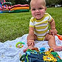 Silas is registered to the contest to win money with this photo: baby, child, grass, outdoor, toy, blanket, onesie, face, infant, play, summer, park, colorful, smile, cute, nature, sitting, fun, inflatable, expression