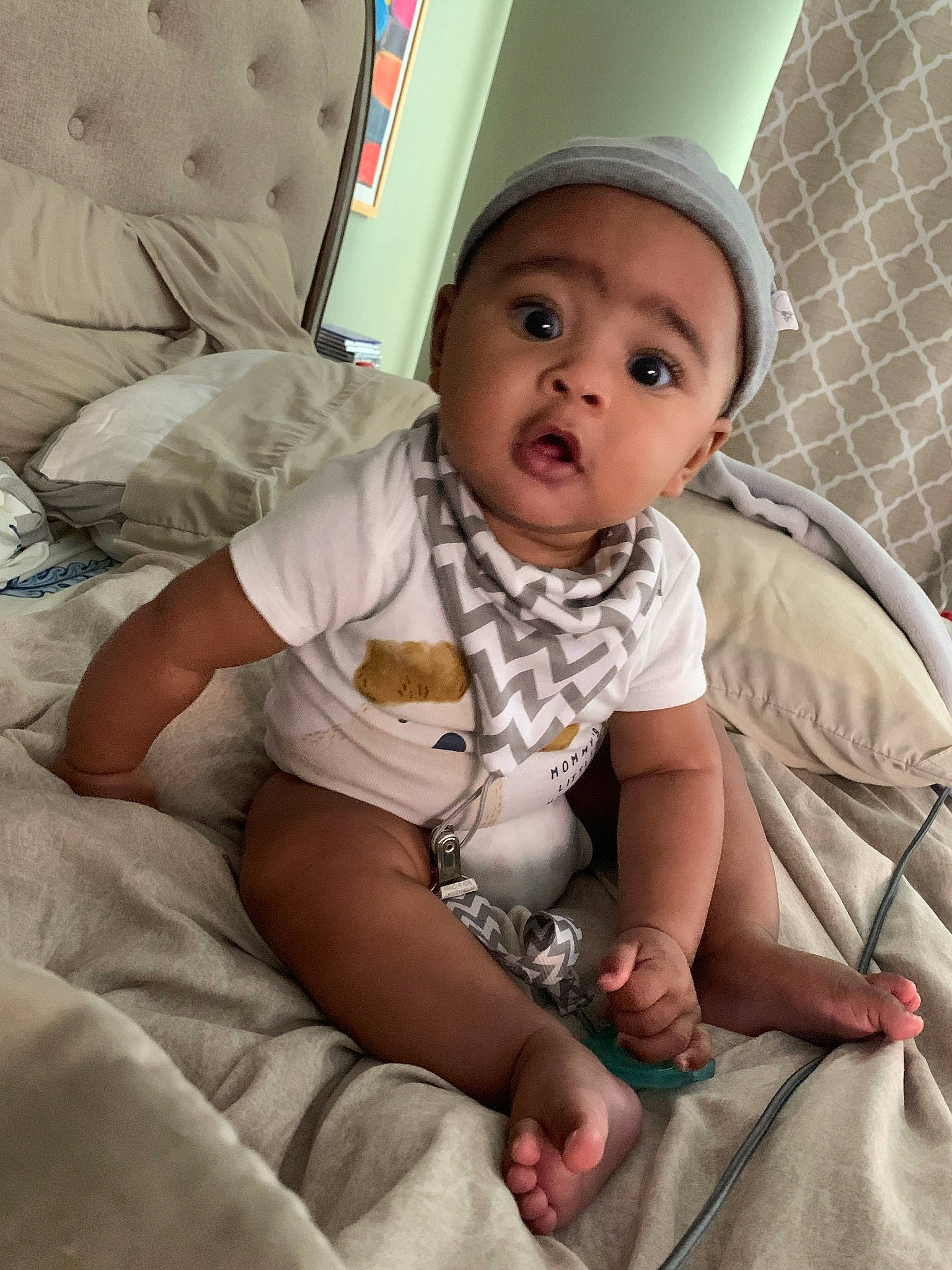 Jakari is registered to the contest to win money with this photo: baby, baby_toddler_clothing, cap, cheek, child, chin, comfort, eye, finger, gesture, hand, happy, human_body, linens, mammal, mouth, person, pink, skin, sleeve