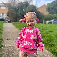 Olivia joined the competition — help win amazing prizes! child, toddler, smile, pink_sweater, barbie, hair_clips, outdoor, sidewalk, grass, pants, cute, happy, person, portrait, fashion, casual_wear, young_child, daylight, greenery, suburban