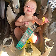 Rosey is registered to the contest to win money with this photo: bare_chest, box, car_seat, child, clothing, cracker, feeding, floor, graco, happy, indoor, laundry_basket, plastic_bag, portrait, seatbelt, smile, snack, sunlight, toddler, young_child