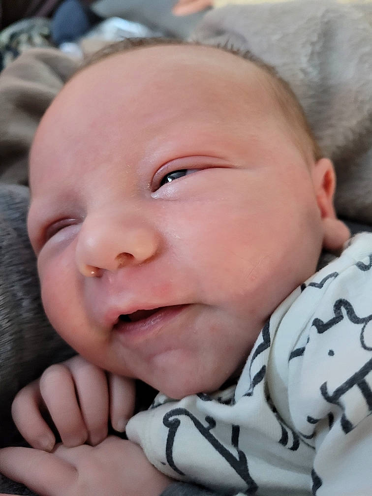 Alonzo is registered to the contest to win money with this photo: baby, baby_toddler_clothing, cheek, comfort, eye, eyebrow, eyelash, finger, gesture, happy, iris, lip, mouth, nose, person, skin, sleeve, smile, textile, thumb