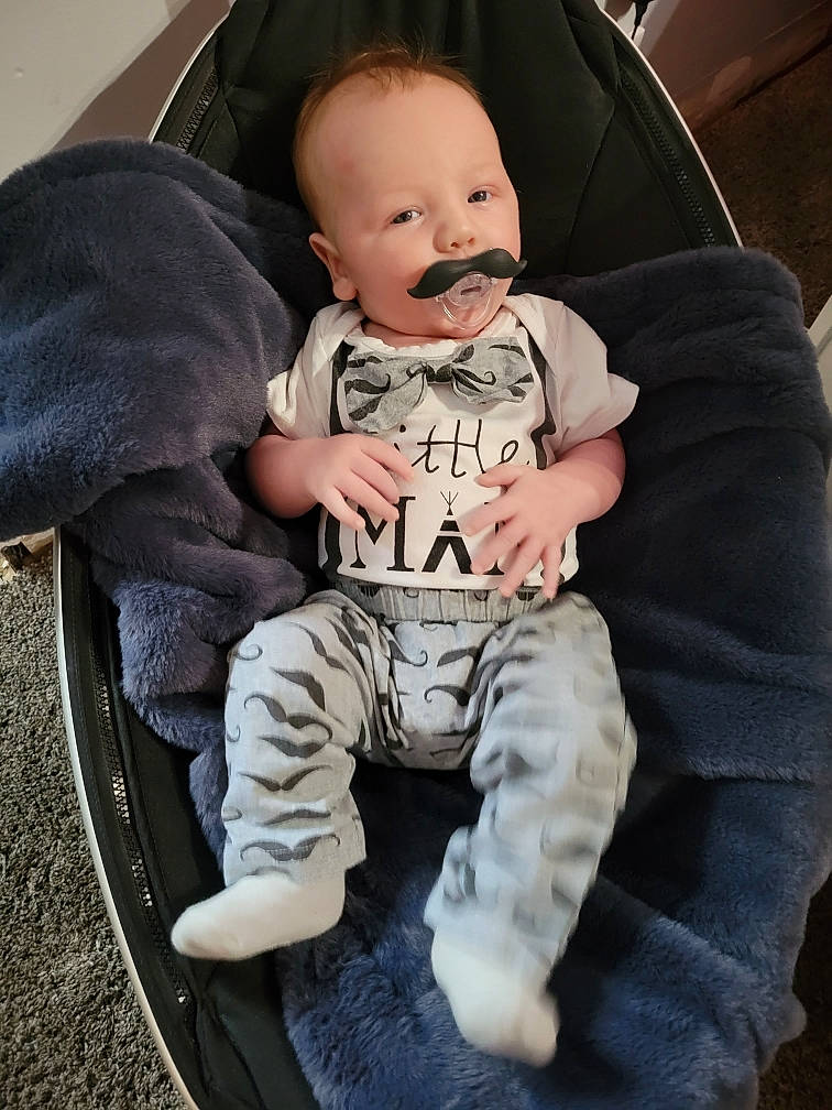 Alonzo joined the competition — help win amazing prizes! baby, baby_products, baby_toddler_clothing, chair, cheek, child, comfort, flash_photography, hairstyle, hand, happy, knee, leg, person, personal_protective_equipment, sitting, sleeve, smile, sneakers, t_shirt