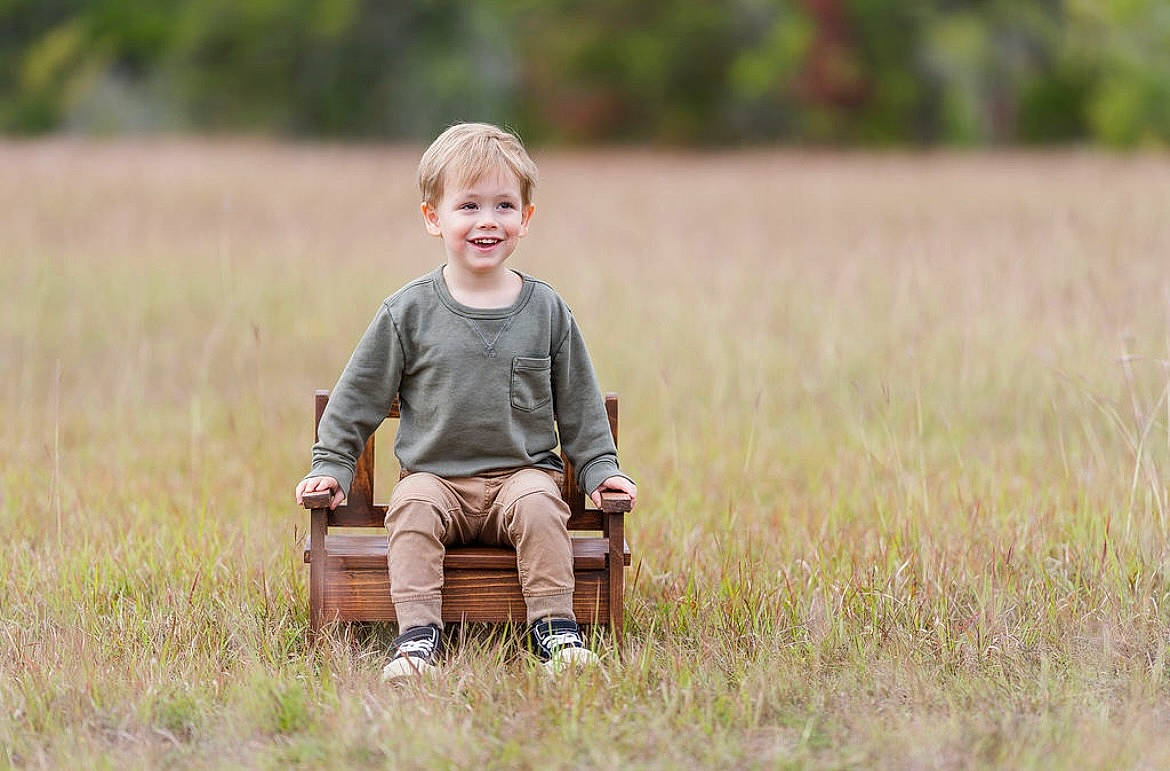 Ryland is registered to the contest to win money with this photo: baby, baby_toddler_clothing, child, dress, face, field, grass, grassland, happy, joy, landscape, meadow, natural_landscape, pattern, people_in_nature, person, plaid, plant, prairie, smile