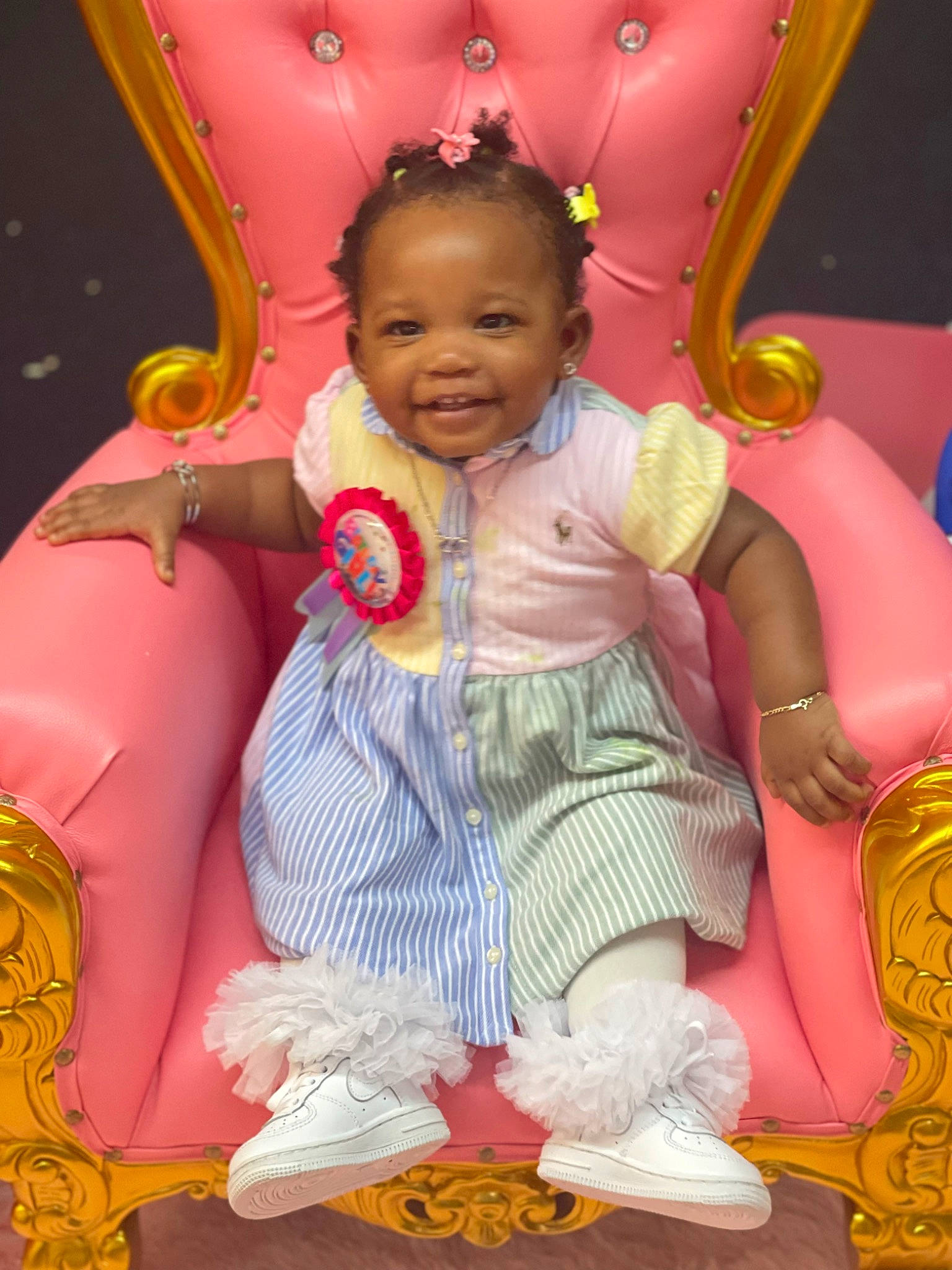 Legacy is registered to the contest to win money with this photo: amusement_ride, baby, baby_toddler_clothing, child, event, fun, happy, joy, leisure, magenta, pattern, person, pink, play, purple, recreation, sitting, smile, textile, toddler