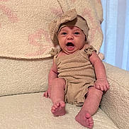 Gianna joined the competition — help win amazing prizes! baby, infant, child, smiling, knitted_outfit, headband, armchair, blanket, cozy, expression, cute, indoors, soft_texture, small_toes, happy, sitting, person, portrait, wearing, comfortable
