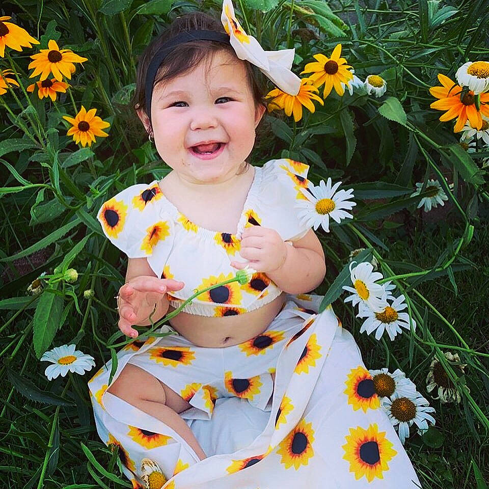 Aubrie is registered to the contest to win money with this photo: baby_toddler_clothing, child, daisy, dress, fawn, flower, joy, pattern, person, petal, plant, smile, spring, sunflower, toddler, wildflower, yellow