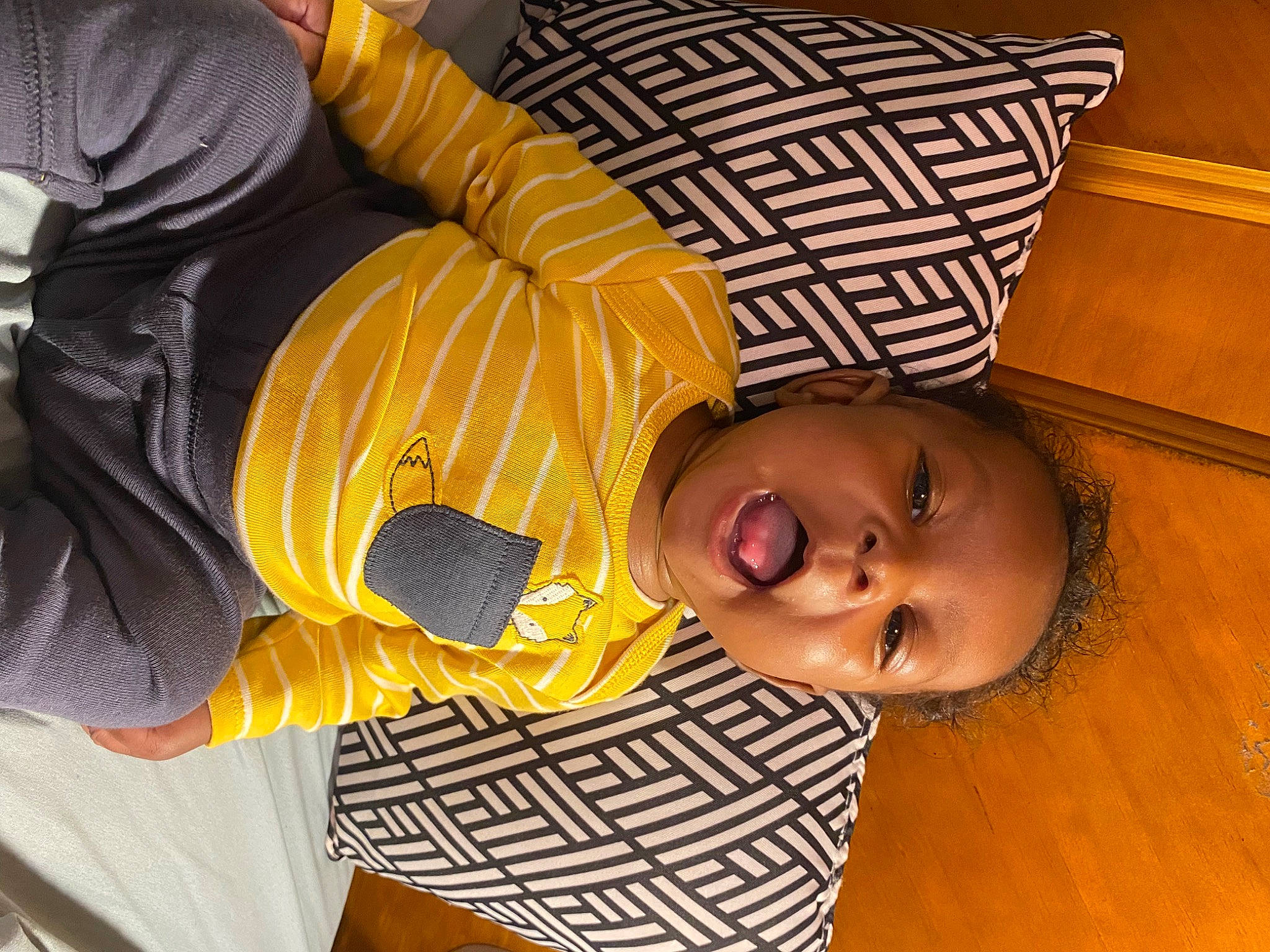 Kyree is registered to the contest to win money with this photo: baby, baby_toddler_clothing, child, comfort, couch, flooring, fun, happy, headgear, linens, mouth, nose, orange, person, room, selfie, sitting, smile, toddler, wood