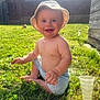 toddler, child, baby, grass, outdoor, sunlight, hat, bucket_hat, smile, happy, shorts, barefoot, nature, backyard, summer, playful, sunny, person, greenery, daytime
