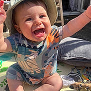 Soul-Atlas is registered to the contest to win money with this photo: arms_up, baby, child, clothing, colorful, cute, expression, face, happy, hat, infant, jingle_bells, joyful, outdoor, playmat, sitting, smiling, sunhat, sunlight, toy
