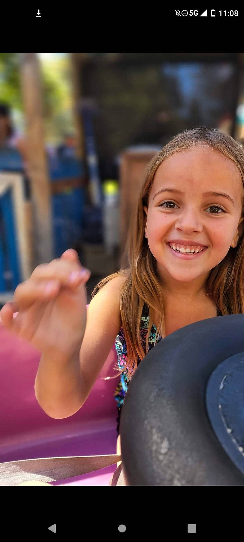 Olivia is registered to the contest to win money with this photo: automotive_tire, automotive_wheel_system, blond, child, electric_blue, event, fun, gesture, happy, joy, laugh, leisure, person, portrait_photography, recreation, sitting, smile, summer, vacation