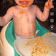 Tallulah is registered to the contest to win money with this photo: toddler, baby, high_chair, food, messy, smiling, face, plate, indoor, child, happy, diaper, feeding, orange_food, cute, funny, mess, person, sitting, portrait