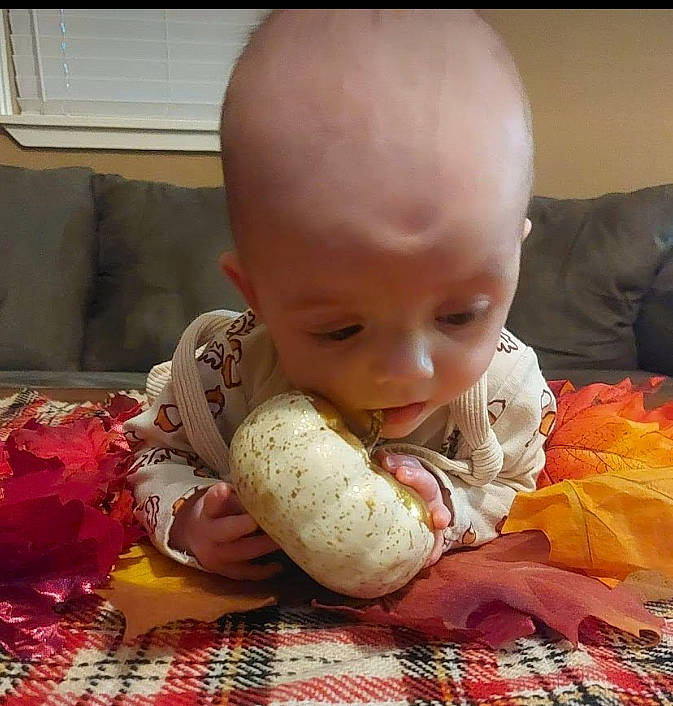 Thea joined the competition — help win amazing prizes! baby, baby_toddler_clothing, carmine, cheek, child, comfort, comfort_food, eating, happy, iris, linens, pattern, person, plaid, room, sitting, tartan, toddler, toy