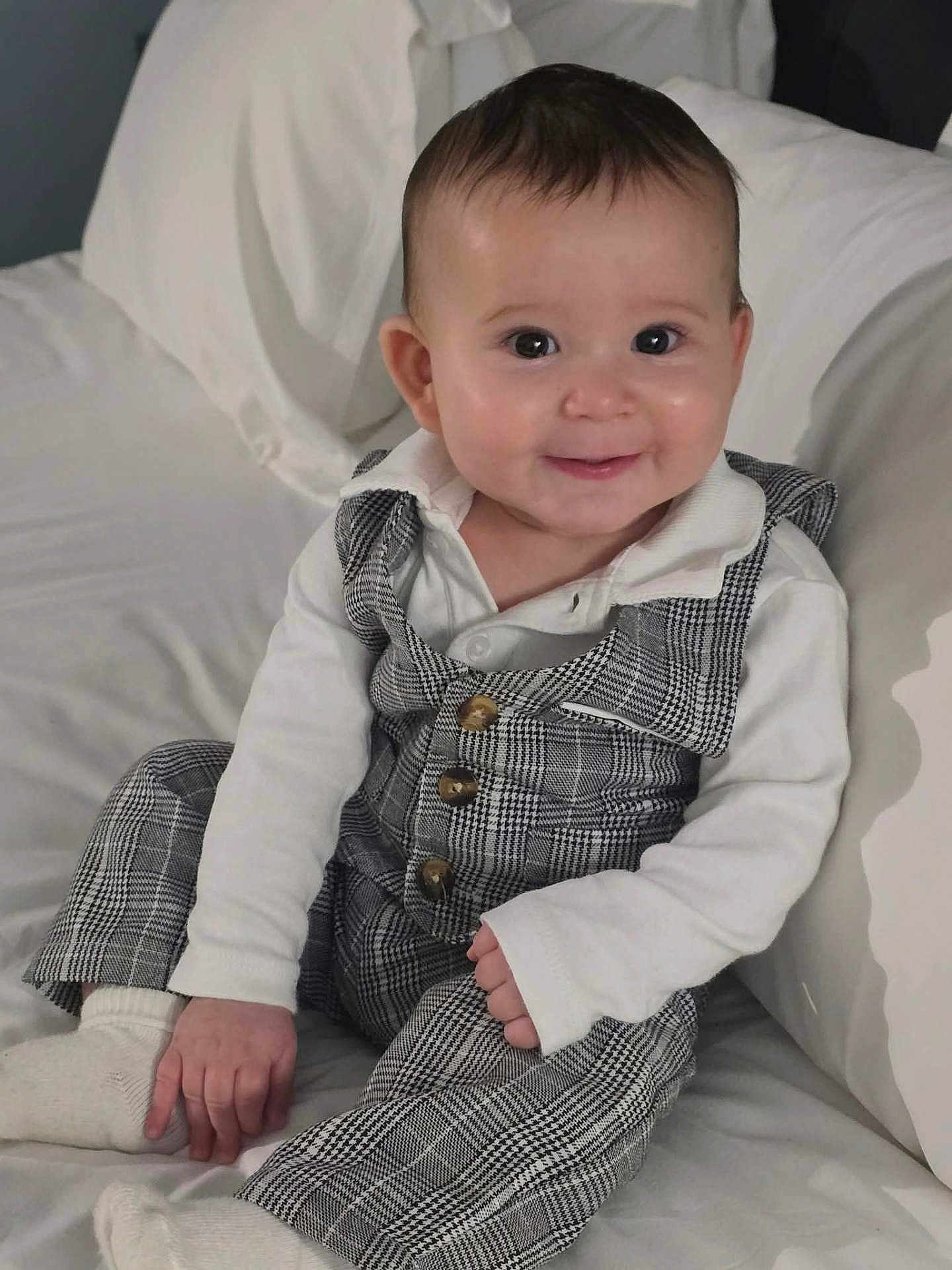 Eben joined the competition — help win amazing prizes! baby, child, smiling, plaid_outfit, white_shirt, couch, indoor, portrait, cute, happy, sitting, infant, face, person, comfortable, soft_lighting, hands, eyes, fashion, cozy