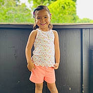 Bri joined the competition — help win amazing prizes! casual_clothing, child, cute, daylight, feet, girl, greenery, hair_clips, happy, nature, outdoor, person, portrait, shoes, shorts, smiling, standing, summer, tank_top, wooden_deck