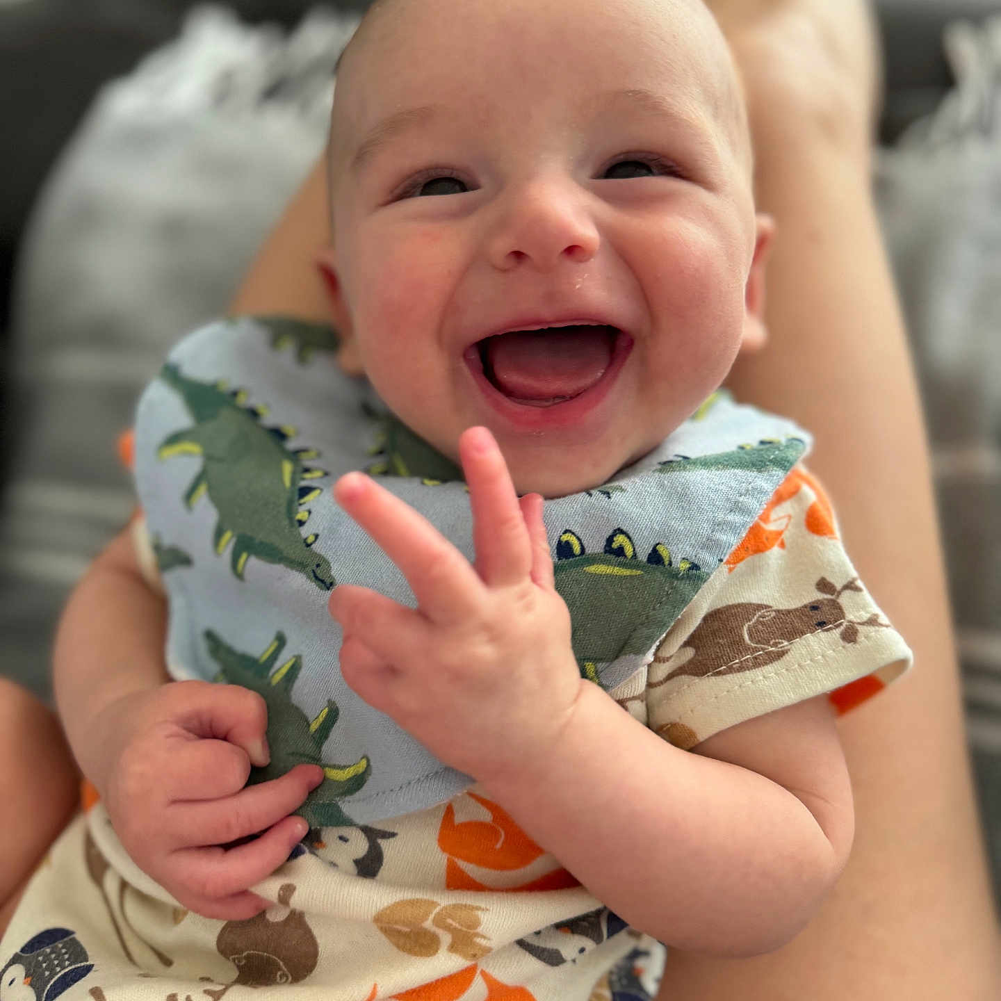 Tatum joined the competition — help win amazing prizes! applique, baby, babylaughing, bodypart, clothing, dress, face, finger, hand, happy, head, laughing, newborn, pattern, person, photography, portrait, smile, t_shirt, wrist