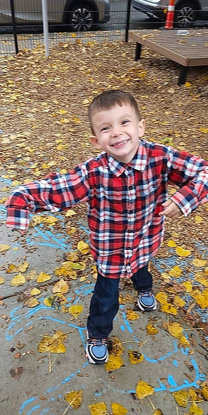 Alonzo is registered to the contest to win money with this photo: child, electric_blue, flooring, fun, grass, happy, joy, leisure, orange, pattern, people_in_nature, person, plaid, play, recreation, sleeve, smile, soil, t_shirt, tartan