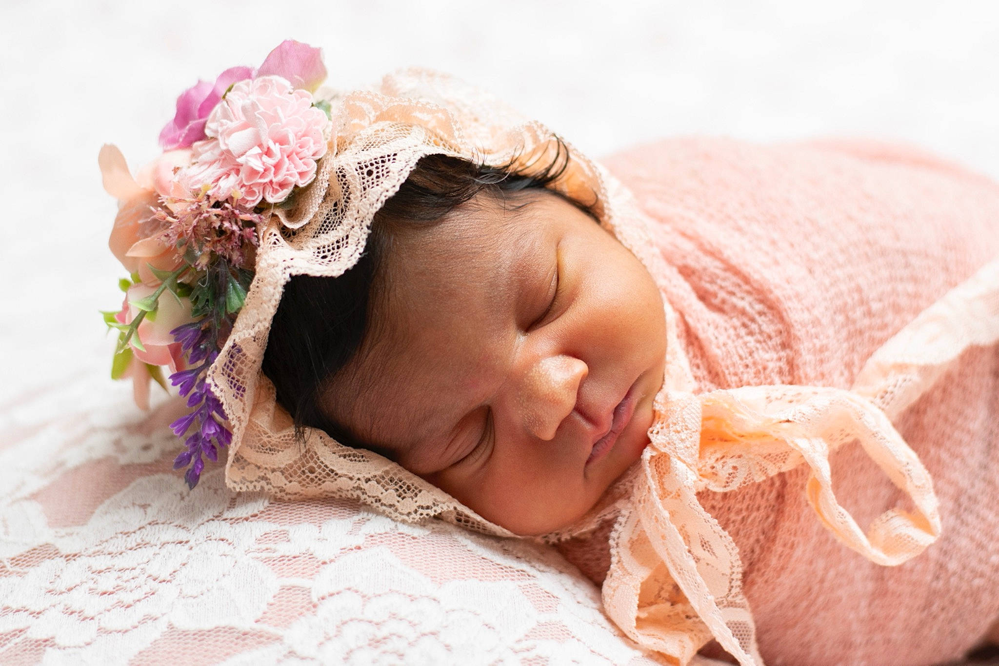 Kalia is registered to the contest to win money with this photo: baby, baby_sleeping, baby_toddler_clothing, child, comfort, eyelash, face, finger, flower, hair_accessory, happy, headgear, headpiece, linens, lip, peach, person, petal, pink, skin