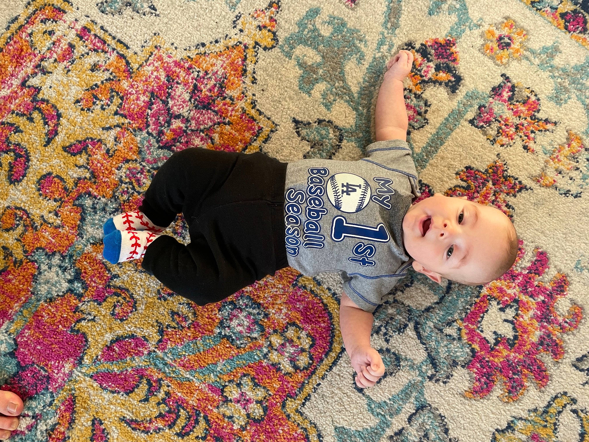 Clay is registered to the contest to win money with this photo: baby, baby_toddler_clothing, child, floor, flooring, fun, grass, happy, human_leg, leg, linens, mammal, pattern, people_in_nature, person, sleeve, t_shirt, textile, thigh, toddler