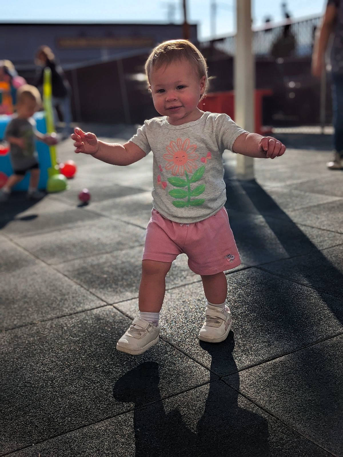 Ellianna is registered to the contest to win money with this photo: asphalt, baby, baby_toddler_clothing, child, city, fun, happy, human_leg, joy, leisure, pedestrian, person, play, recreation, road, shorts, sky, sleeve, smile, street