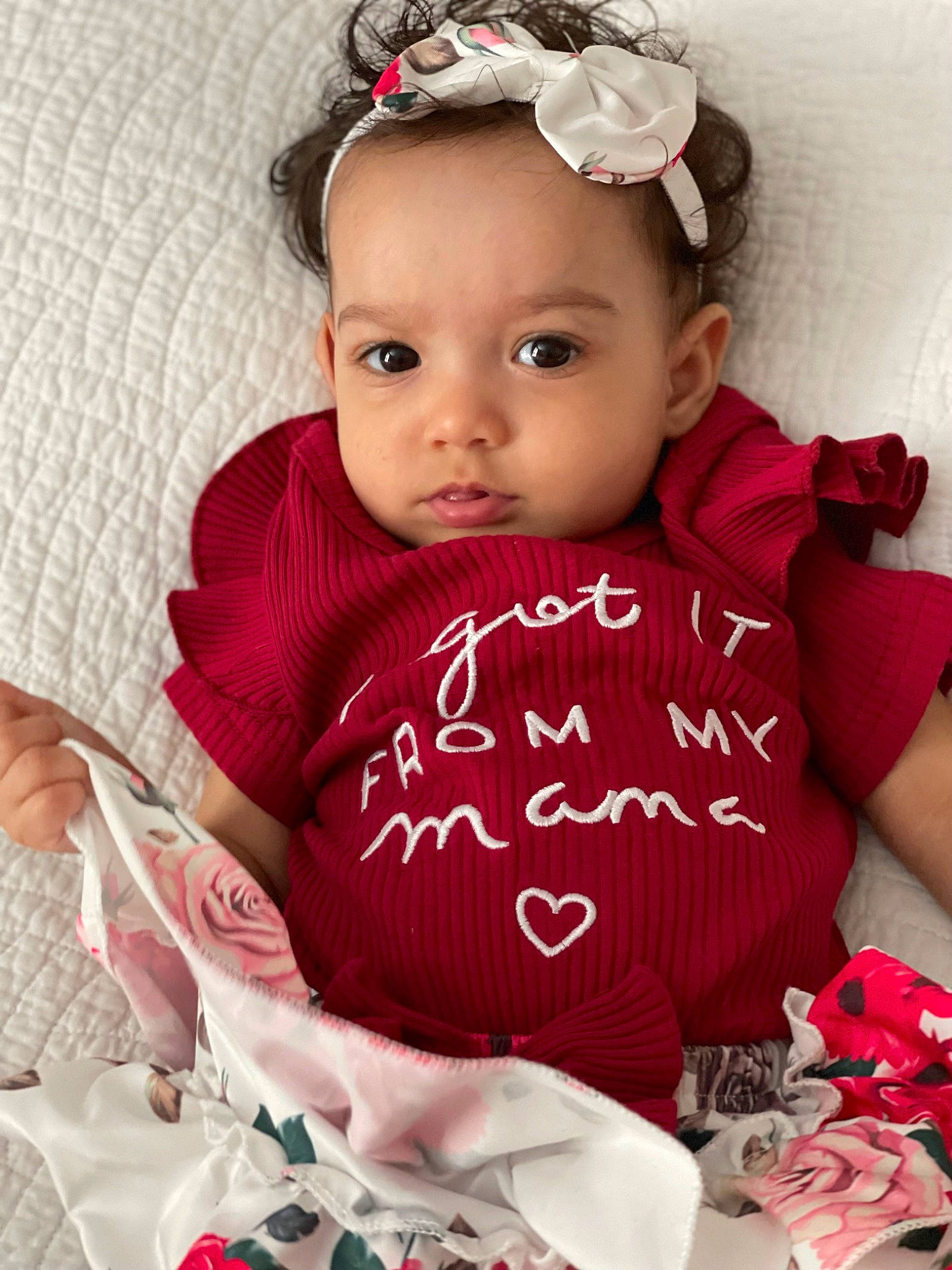 Mariah is registered to the contest to win money with this photo: arm, baby, baby_toddler_clothing, cool, dress, eyelash, face, happy, headband, headgear, headpiece, headwear, jewellery, lip, person, petal, pink, skin, sleeve, textile