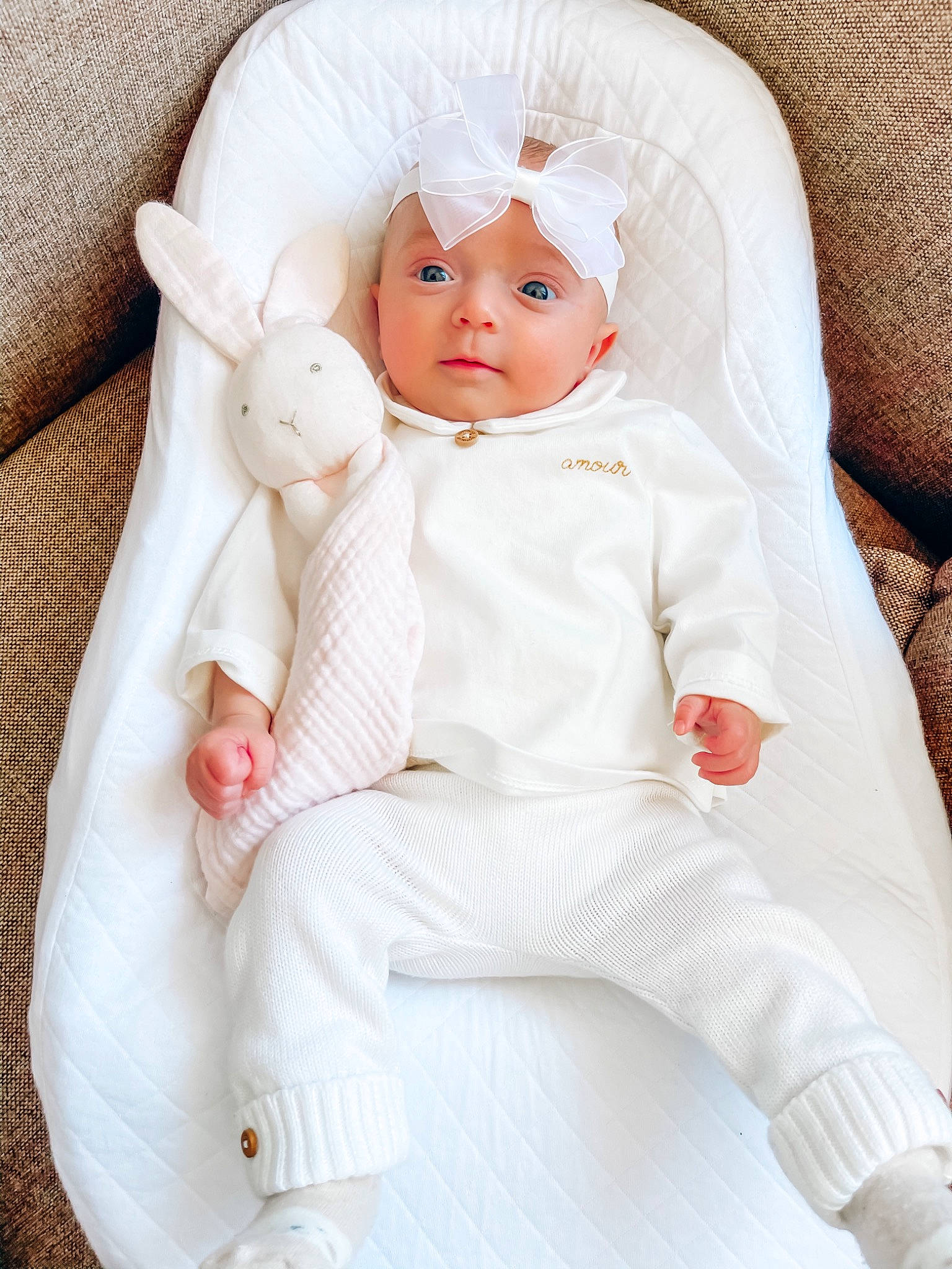 Carla participe au concours pour gagner de l'argent avec cette photo : baby, baby_products, baby_toddler_clothing, cheek, comfort, doll, eye, eyelash, face, head, headgear, headwear, iris, linens, lip, peach, person, pink, skin, sleeve