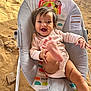 baby, infant, smiling, happy, bouncer, baby_bouncer, clothing, foot, hand, face, person, indoor, colorful, pattern, animal_illustration, monkey, sun, rainbow, sand, rock