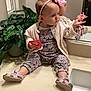 toddler, child, pink_bow, headband, bathroom, mirror, plant, countertop, sink, reflection, clothing, sandals, floral_pattern, pensive, indoor, person, young_child, holding_object, casual, home