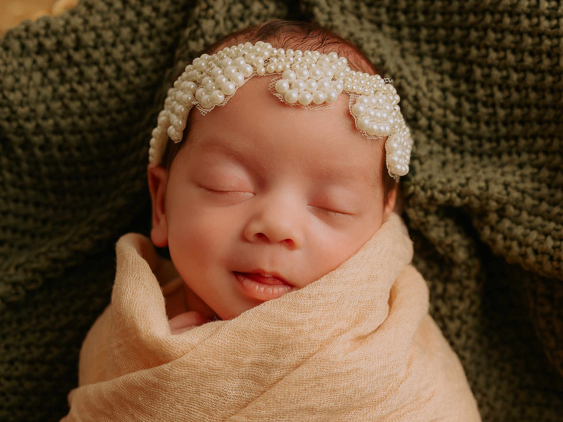 Kamille is registered to the contest to win money with this photo: newborn, baby, sleeping, pearl_headband, blanket, wrapped, closeup, portrait, infant, soft_texture, knitted_background, peaceful, cute, head, face, skin, indoors, resting, calm, child