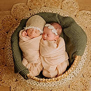 Kamille is registered to the contest to win money with this photo: newborn, baby, basket, blanket, knit, sleeping, headband, hat, woven_rug, wooden_floor, cozy, infant, wrapped, peaceful, cute, two_babies, indoor, soft_lighting, portrait, resting