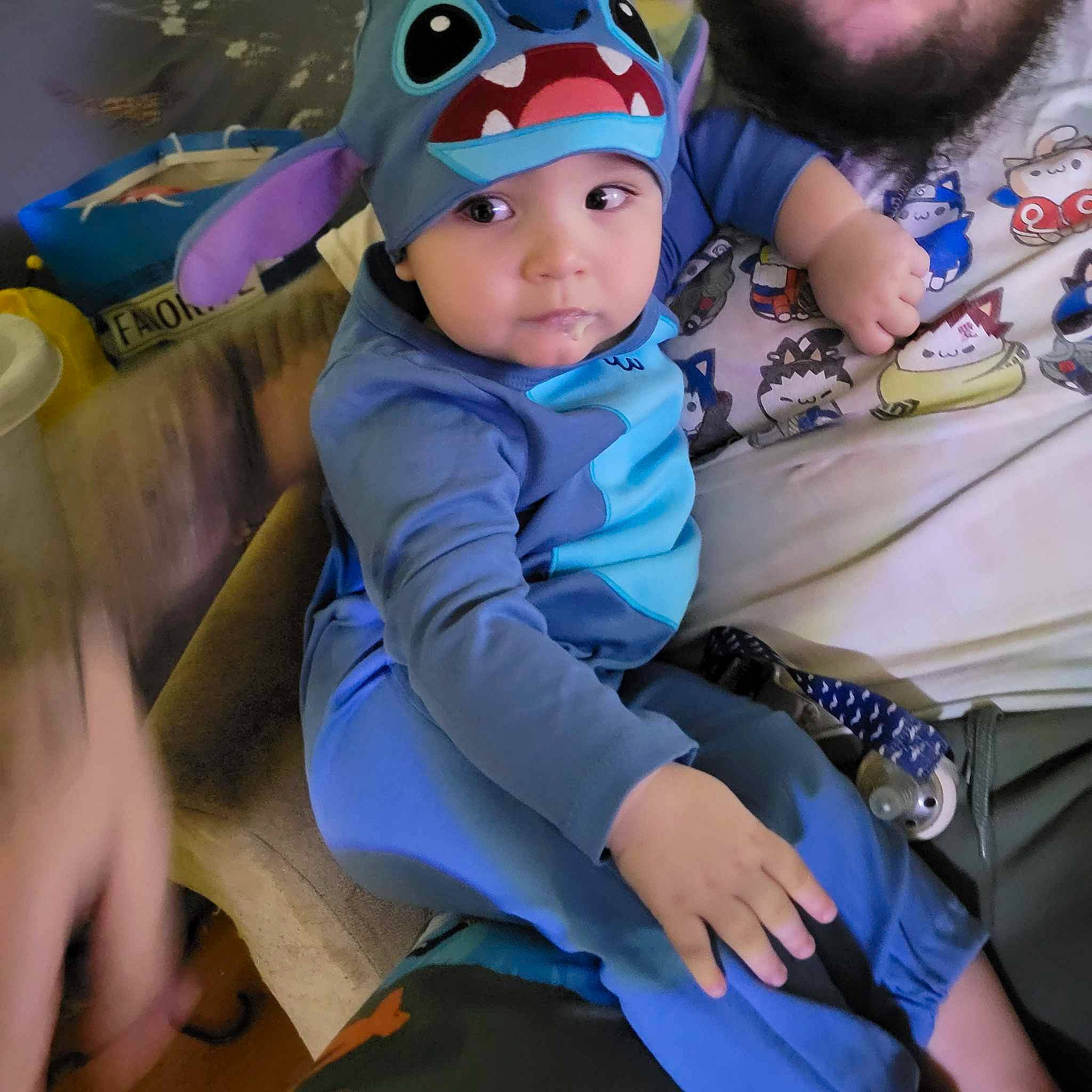 Damien is registered to the contest to win money with this photo: baby, baby_toddler_clothing, blue, cap, child, cool, electric_blue, event, face, fictional_character, fun, happy, headwear, leisure, people, person, personal_protective_equipment, purple, recreation, sitting