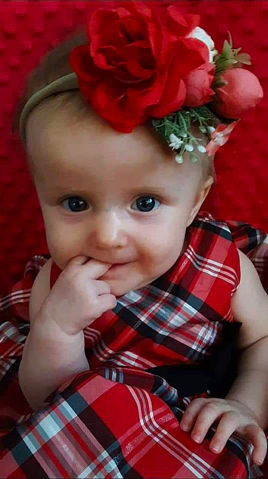 Dahlia joined the competition — help win amazing prizes! baby, cheek, child, design, flower, hair_accessory, headgear, joy, mouth, nose, pattern, person, petal, plaid, plant, red, smile, tartan, textile, toddler