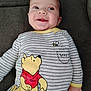 baby, child, smile, winnie_the_pooh, striped_clothing, bee, honey_pot, couch, fabric, hand, infant, portrait, happy, indoors, cute, young_child, casual, clothing, sitting, relaxed
