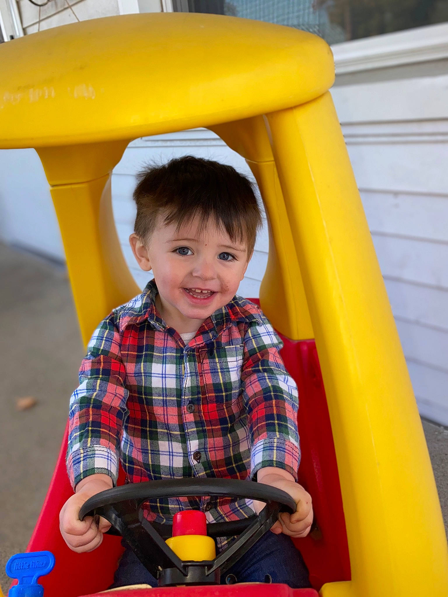 Braylon is registered to the contest to win money with this photo: child, city, clothing, facial_expression, fun, happy, joy, leisure, people, person, photograph, playground, product, public_space, red, riding_toy, smile, snapshot, standing, toddler