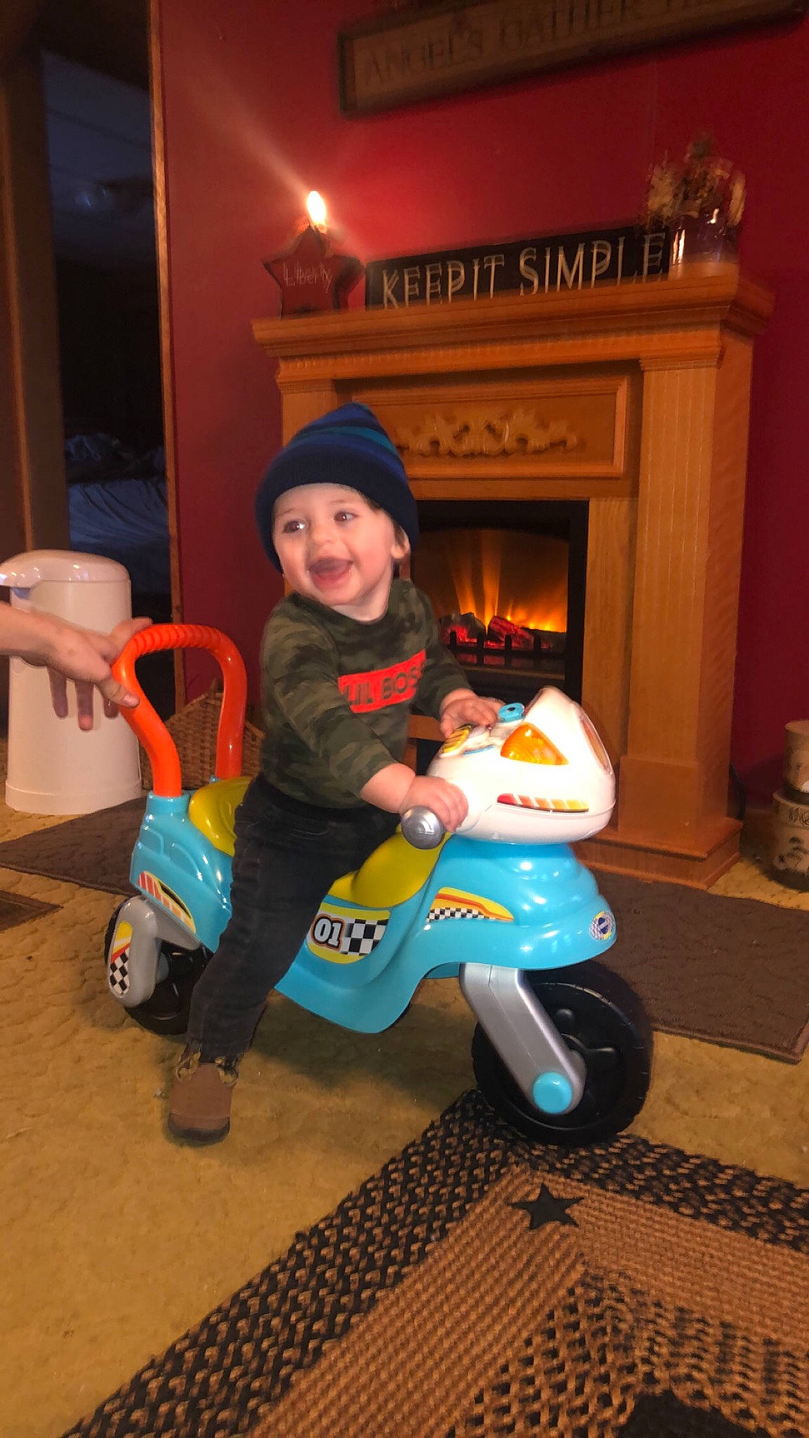 Braylon is registered to the contest to win money with this photo: baby_products, baby_toddler_clothing, child, costume, electric_blue, flooring, fun, hat, headwear, lap, person, picture_frame, recreation, riding_toy, sitting, smile, sneakers, tire, toddler, toy