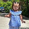 Clarette Amelia is registered to the contest to win money with this photo: child, girl, pigtails, blue_top, white_shorts, outdoor, sunlight, shadow, sidewalk, trees, greenery, car, summer, smile, cute, walking, daylight, person, casual_clothing, nature