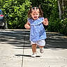 Clarette Amelia is registered to the contest to win money with this photo: toddler, child, running, outdoor, sidewalk, greenery, sunlight, pigtails, blue_dress, white_shorts, shoes, expression, car, tree, shadow, concrete, daytime, person, nature, playful