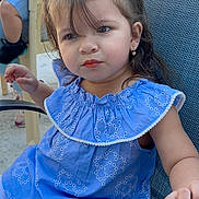 Clarette is registered to the contest to win money with this photo: child, toddler, girl, blue_dress, pigtails, earrings, chair, outdoor, family, portrait, casual, summer, cute, expression, seated, person, daylight, young_child, people, clothing