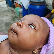 Miracle joined the competition — help win amazing prizes! baby, child, face, headband, earrings, outdoor, curious, looking_up, skin, portrait, close_up, person, infant, ear, expression, head, young, background_blur, container, colorful
