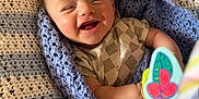 Camden is registered to the contest to win money with this photo: baby, smiling, infant, blanket, knitted, blue, white, toy, butterfly, happy, cute, child, wrapped, cozy, portrait, indoor, closeup, face, cheerful, playful