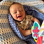 baby, smiling, infant, blanket, knitted, blue, white, toy, butterfly, happy, cute, child, wrapped, cozy, portrait, indoor, closeup, face, cheerful, playful
