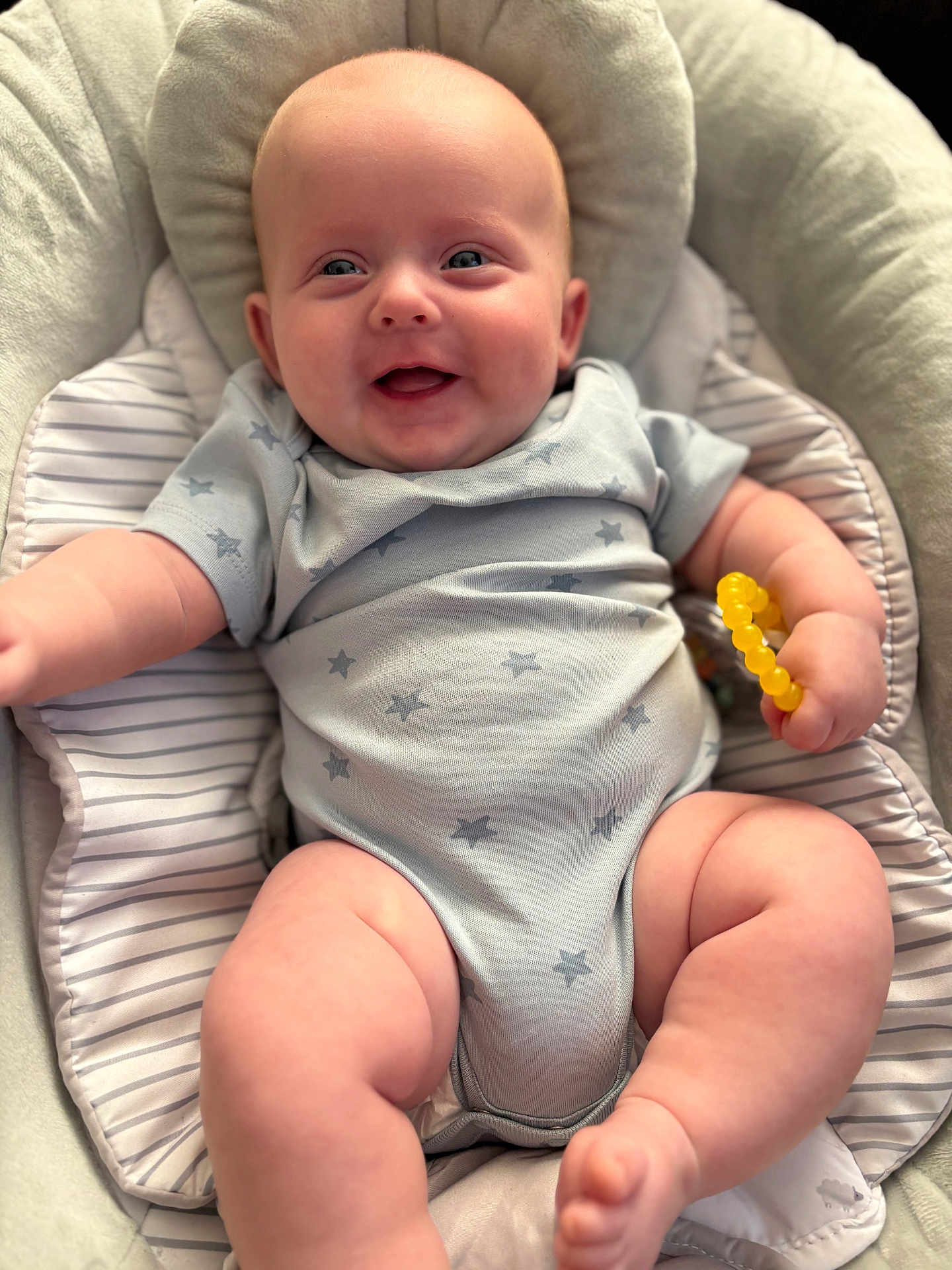Myles joined the competition — help win amazing prizes! baby, infant, smiling, onesie, star_pattern, teething_ring, cushion, baby_seat, chubby, happy, child, skin, hand, foot, indoor, closeup, cute, portrait, plush, comfort