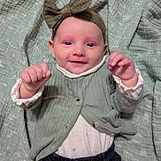 Blaney joined the competition — help win amazing prizes! baby, infant, headband, bow, cardigan, clothing, blanket, smiling, happy, raised_hands, cute, portrait, child, toddler, indoor, fabric, texture, face, person, jeans